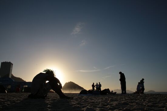 Argentine football fans see sunrise in Copacabana Beach