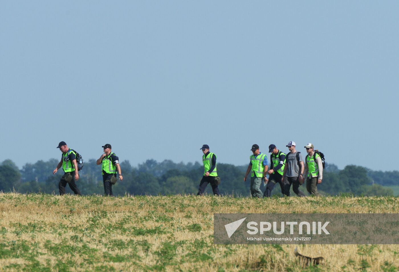 Experts and OSCE representatives work at Boeing crash site