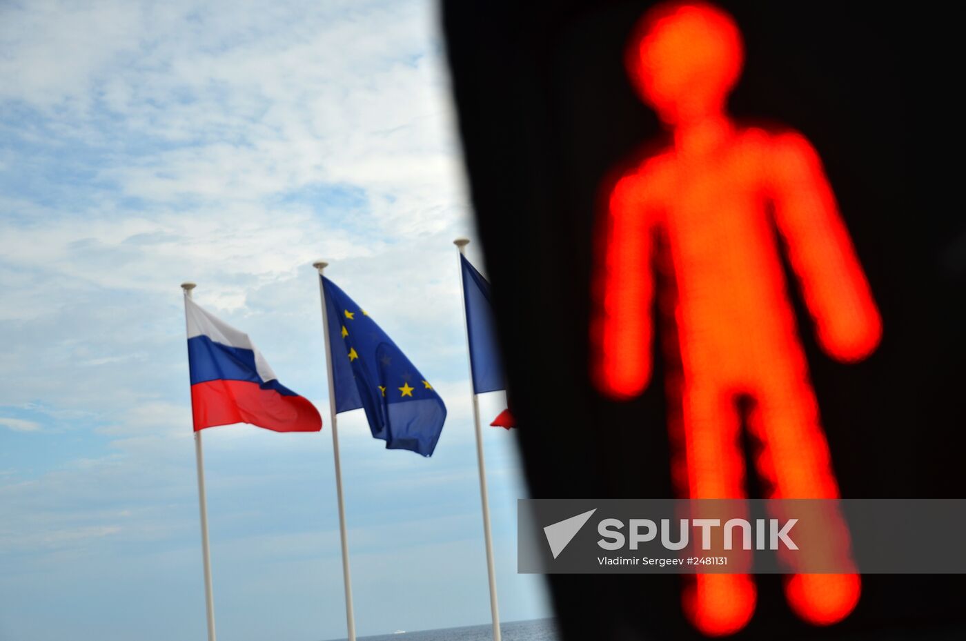 Flags of Russia, EU, France and coat of arms of Nice on the city's promenade
