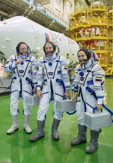 Soyuz TMA-14M crew members inspect spacecraft and try on their space suits