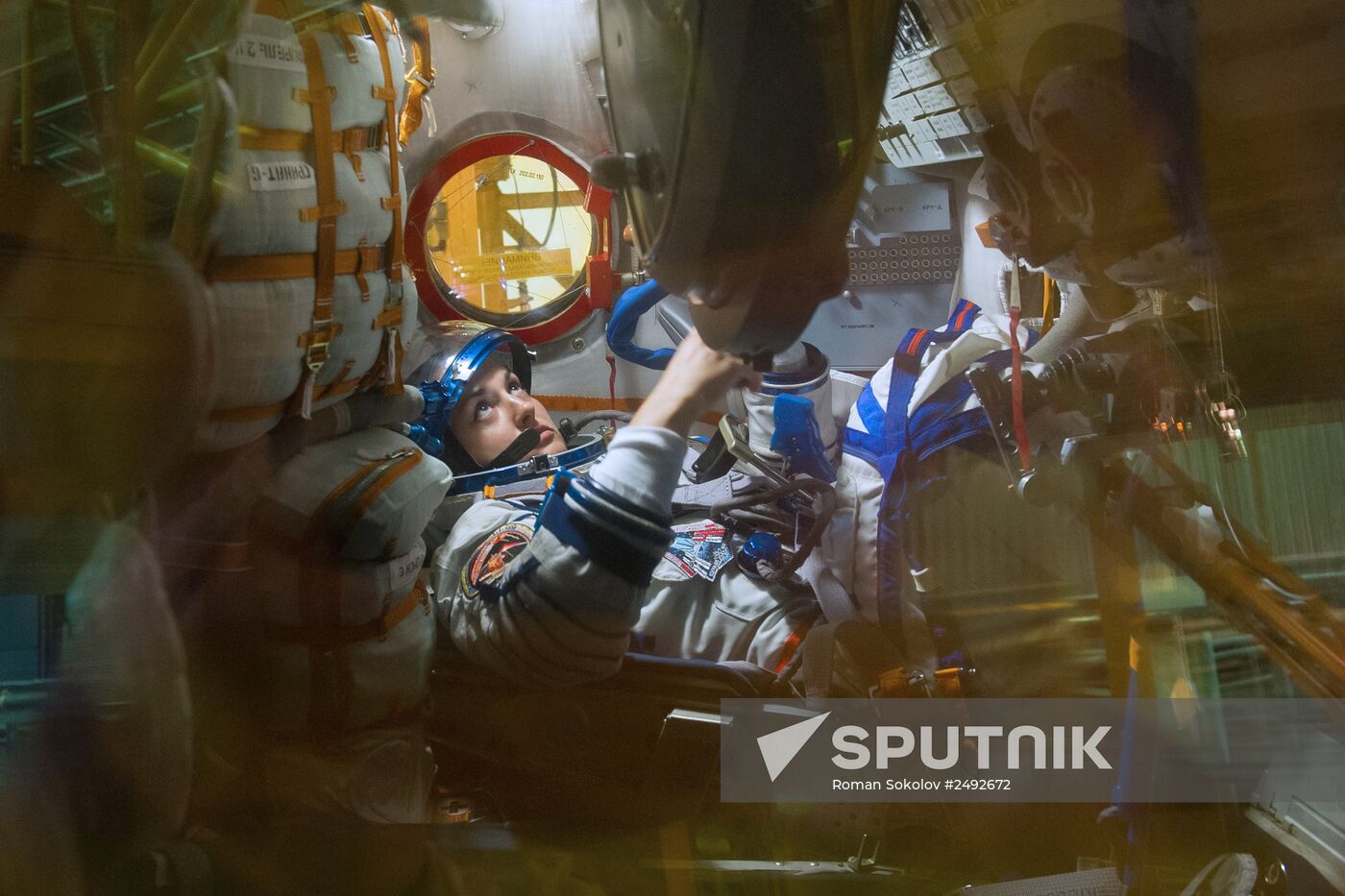 Soyuz TMA-14M crew members inspect spacecraft and try on their space suits