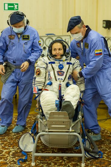 Soyuz TMA-14M crew members inspect spacecraft and try on their space suits
