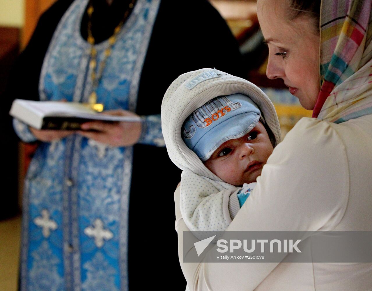 Baptizing an infant at the Church of St. Nicholas the Wonderworker in Vladivostok