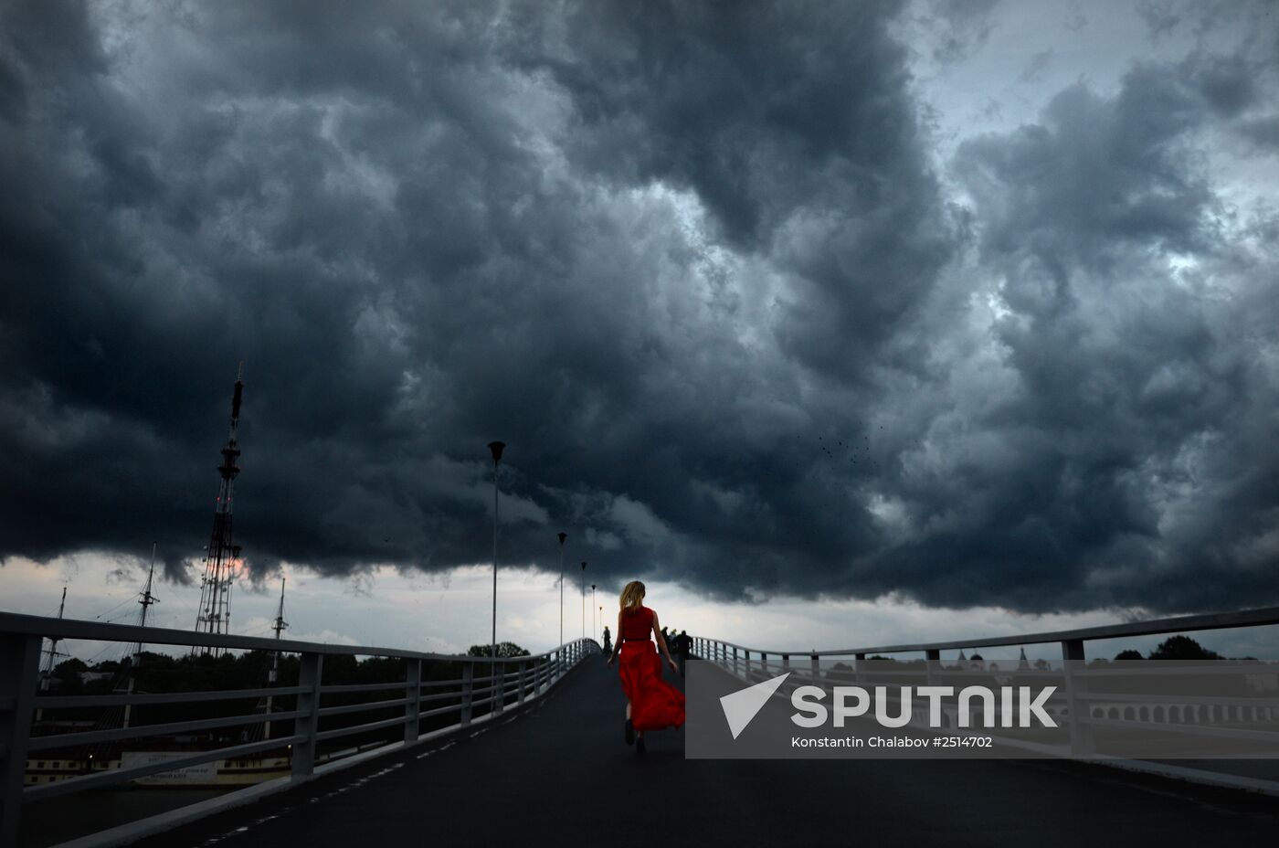 A young woman runs on a footbridge in Veliky Novgorod