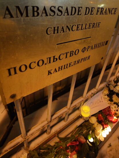 People lay flower by French Embassy in Moscow