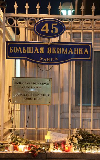 People lay flower by French Embassy in Moscow
