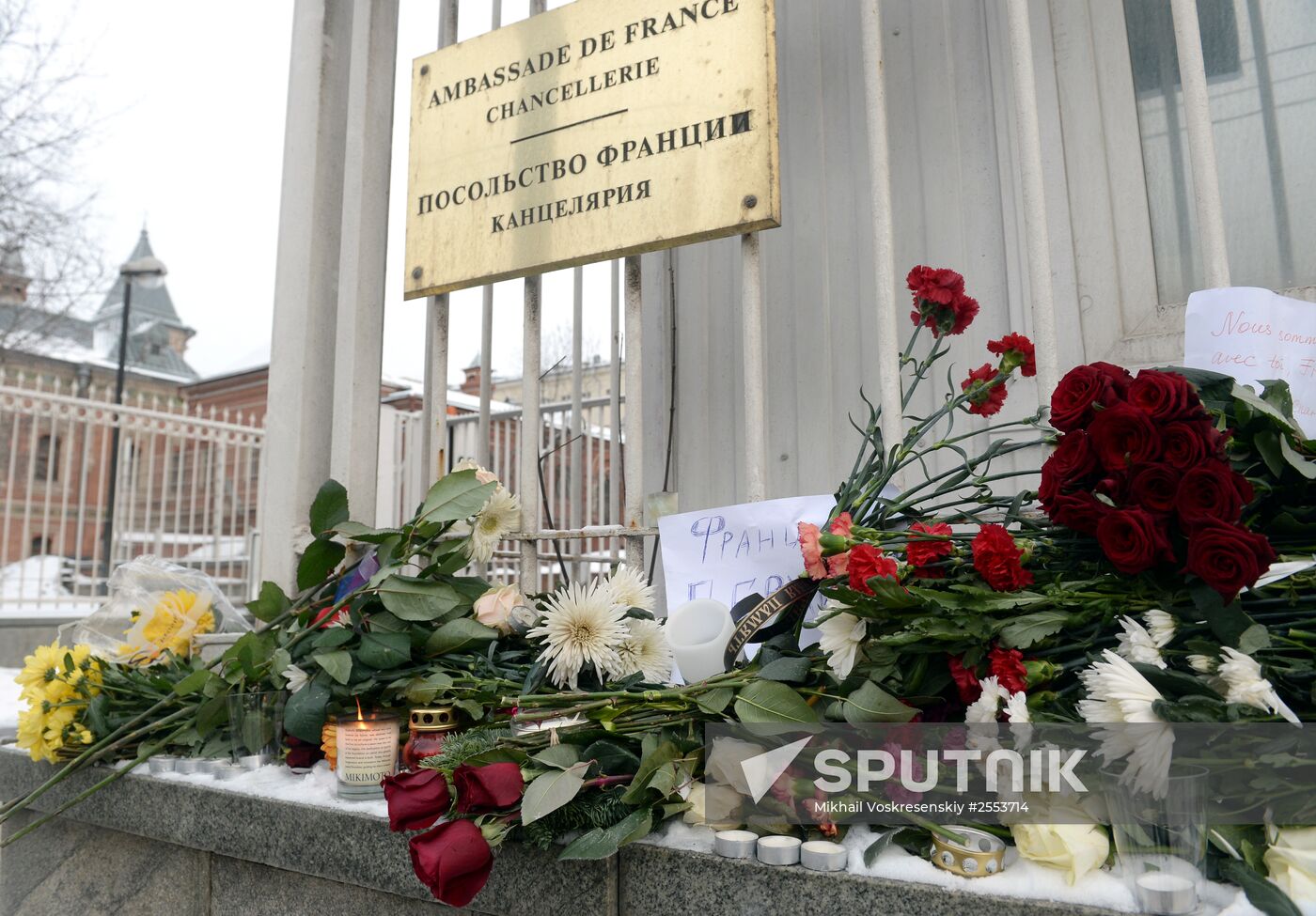 People bring flowers and candles to French embassy in Moscow