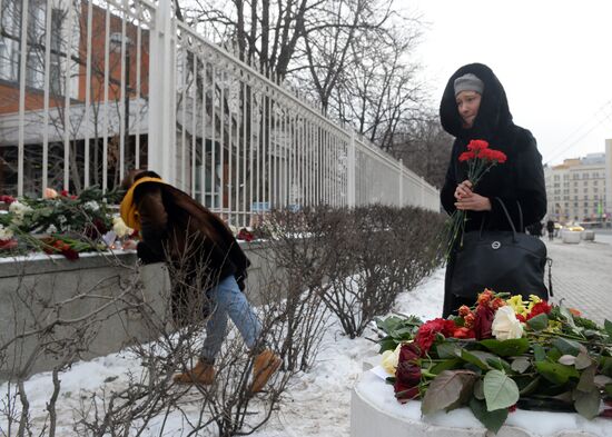 People bring flowers and candles to French embassy in Moscow