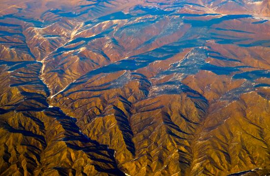 View of mountains in Mongolia from an airplane window