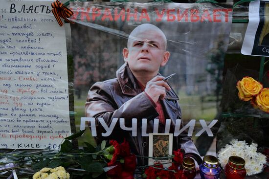 Flowers and candles by Ukrainian embassy in Moscow in memory of journalist Oles Buzina killed in Kiev