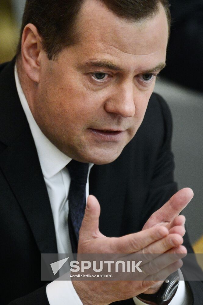 April 21, 2015. Russian Prime Minister Dmitry Medvedev, foreground, replies to MPs' questions, after reporting on the Government's 2014 performance at the State Duma of the Russian Federation. Location: Russia, Moscow. Author: Ramil Sitdikov/Sputnik. Dmitry Medvedev reports on the Government's performance at the State Duma of the Russian Federation