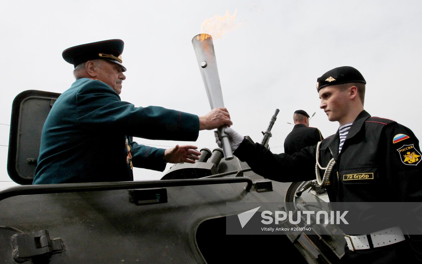 Lighting a torch at the Pacific Fleet's Combat Glory memorial in Vladivostok