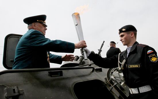 Lighting a torch at the Pacific Fleet's Combat Glory memorial in Vladivostok