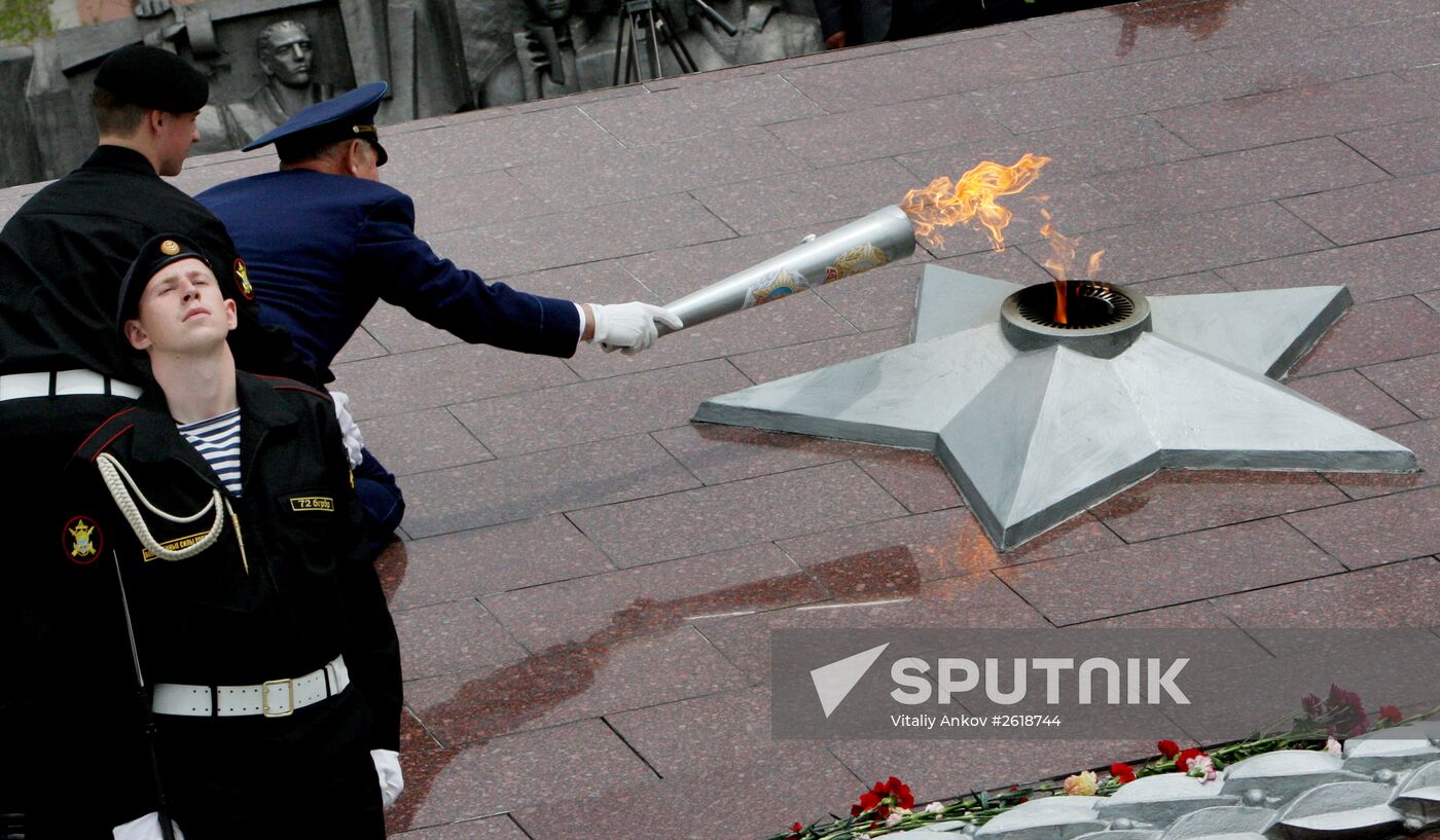 Lighting a torch at the Pacific Fleet's Combat Glory memorial in Vladivostok