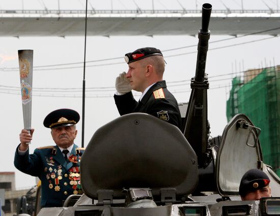 Lighting a torch at the Pacific Fleet's Combat Glory memorial in Vladivostok