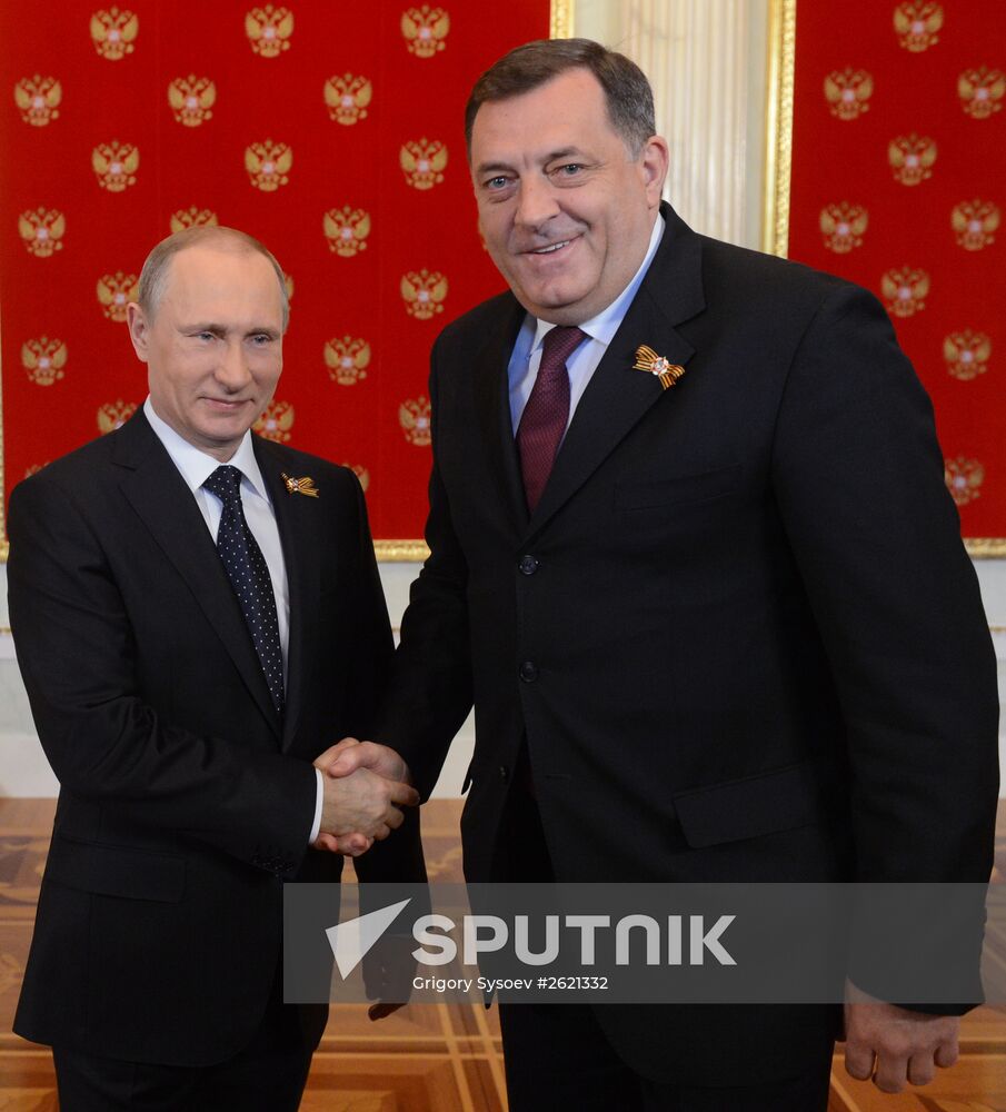 Russian President Vladimir Putin welcomes foreign delegation heads and honorary guests