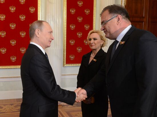 Russian President Vladimir Putin welcomes foreign delegation heads and honorary guests