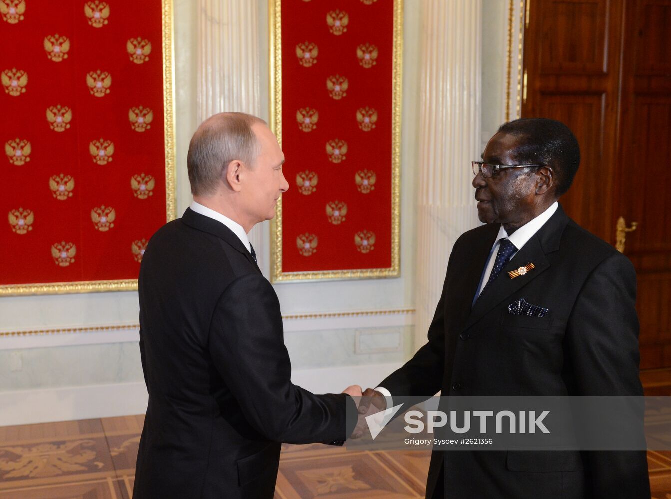 Russian President Vladimir Putin welcomes foreign delegation heads and honorary guests