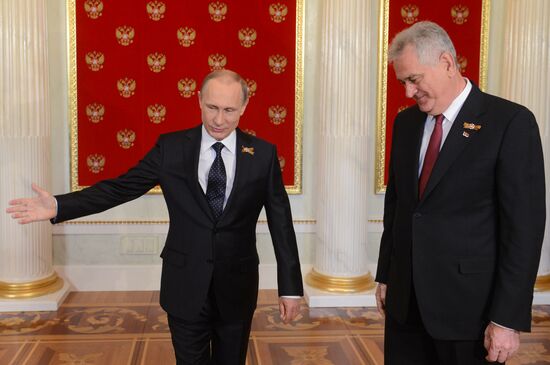 Russian President Vladimir Putin welcomes foreign delegation heads and honorary guests