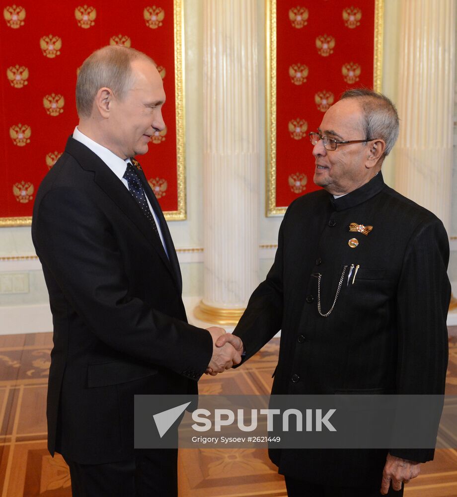 Russian President Vladimir Putin welcomes foreign delegation heads and honorary guests