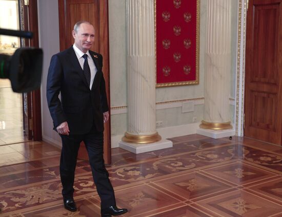 Russian President Vladimir Putin welcomes foreign delegation heads and honorary guests