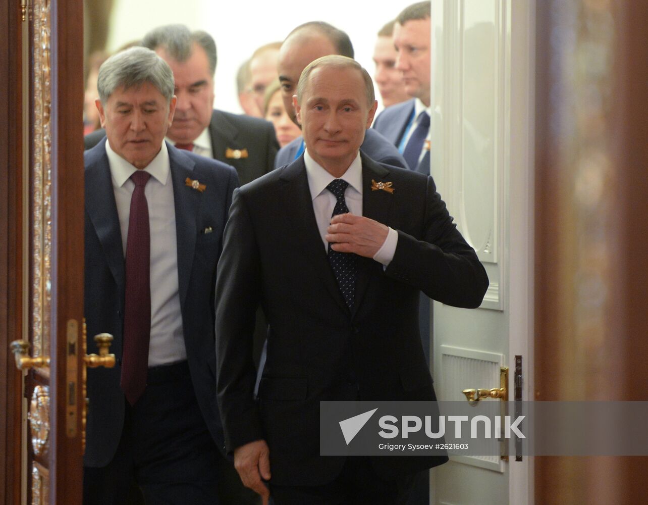 Russian President Vladimir Putin welcomes foreign delegation heads and honorary guests