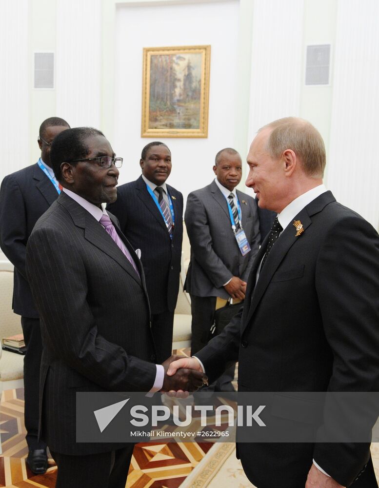 Russian President Vladimir Putin meets with President of Zimbabwe Robert Mugabe