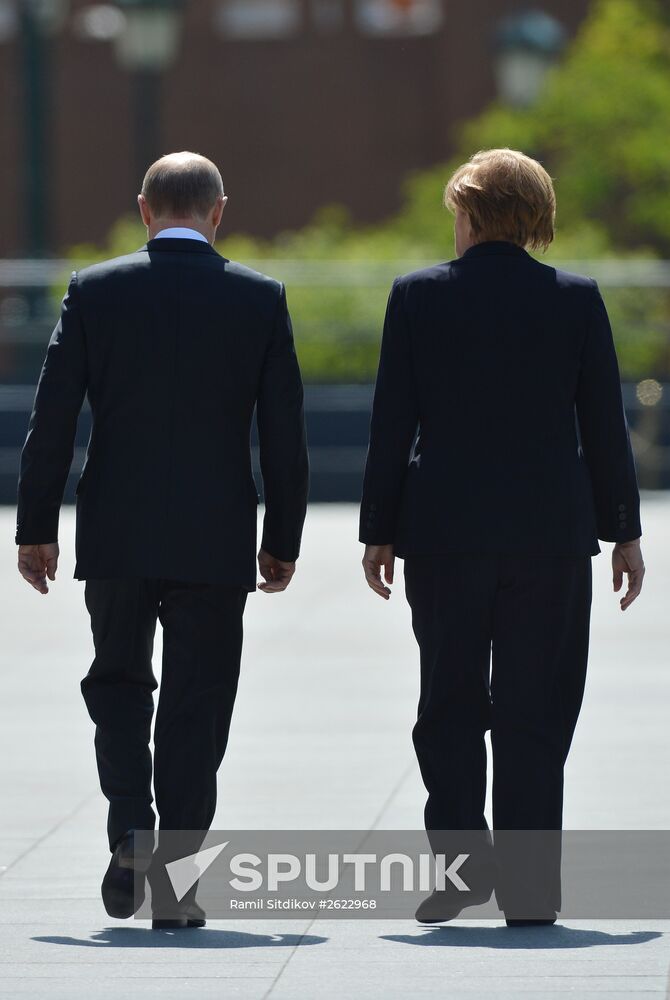 Vladimir Putin and German Chancellor Angela Merkel lay flowers at Tomb of the Unknown Soldier