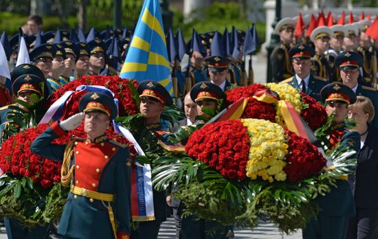 Vladimir Putin and German Chancellor Angela Merkel lay flowers at Tomb of the Unknown Soldier