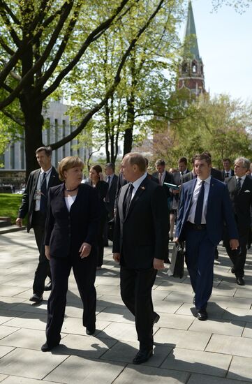 Vladimir Putin and German Chancellor Angela Merkel lay flowers at Tomb of the Unknown Soldier