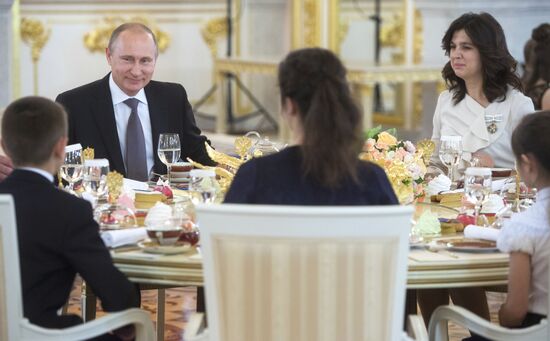Russian President V.Putin presents Orders of Parental Glory to parents of large families
