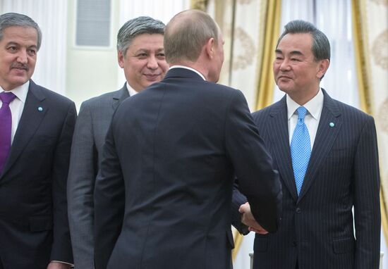 Russian President Vladimir Putin meets with attendees at SCO Council of Ministers of Foreign Affairs Meeting in Kremlin