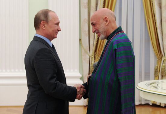 Vladimir Putin meets with former Afghan President Hamid Karzai