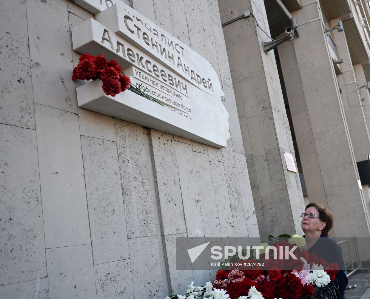 Leaving flowers by plaque in memory of Andrei Stenin