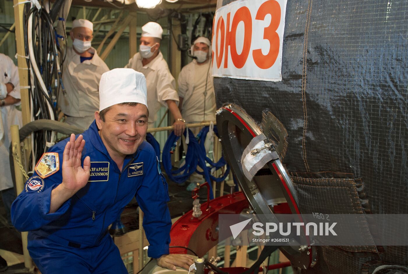 ISS-45/46 and Visiting Expedition 18 primary crew try on space suits and inspect space ship