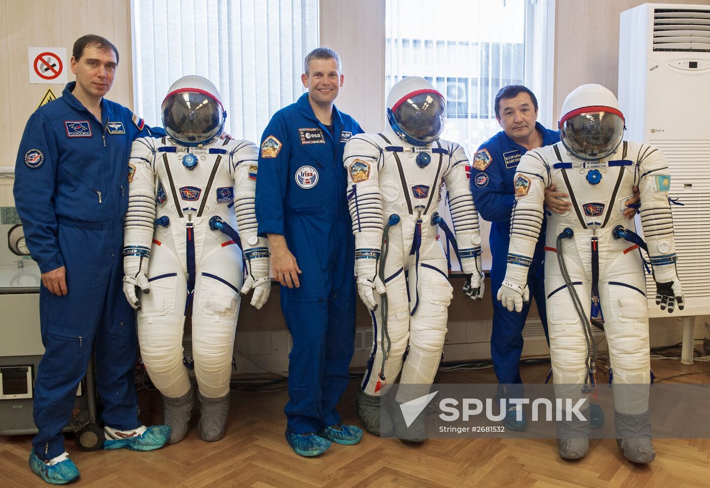 ISS-45/46 and Visiting Expedition 18 primary crew try on space suits and inspect space ship
