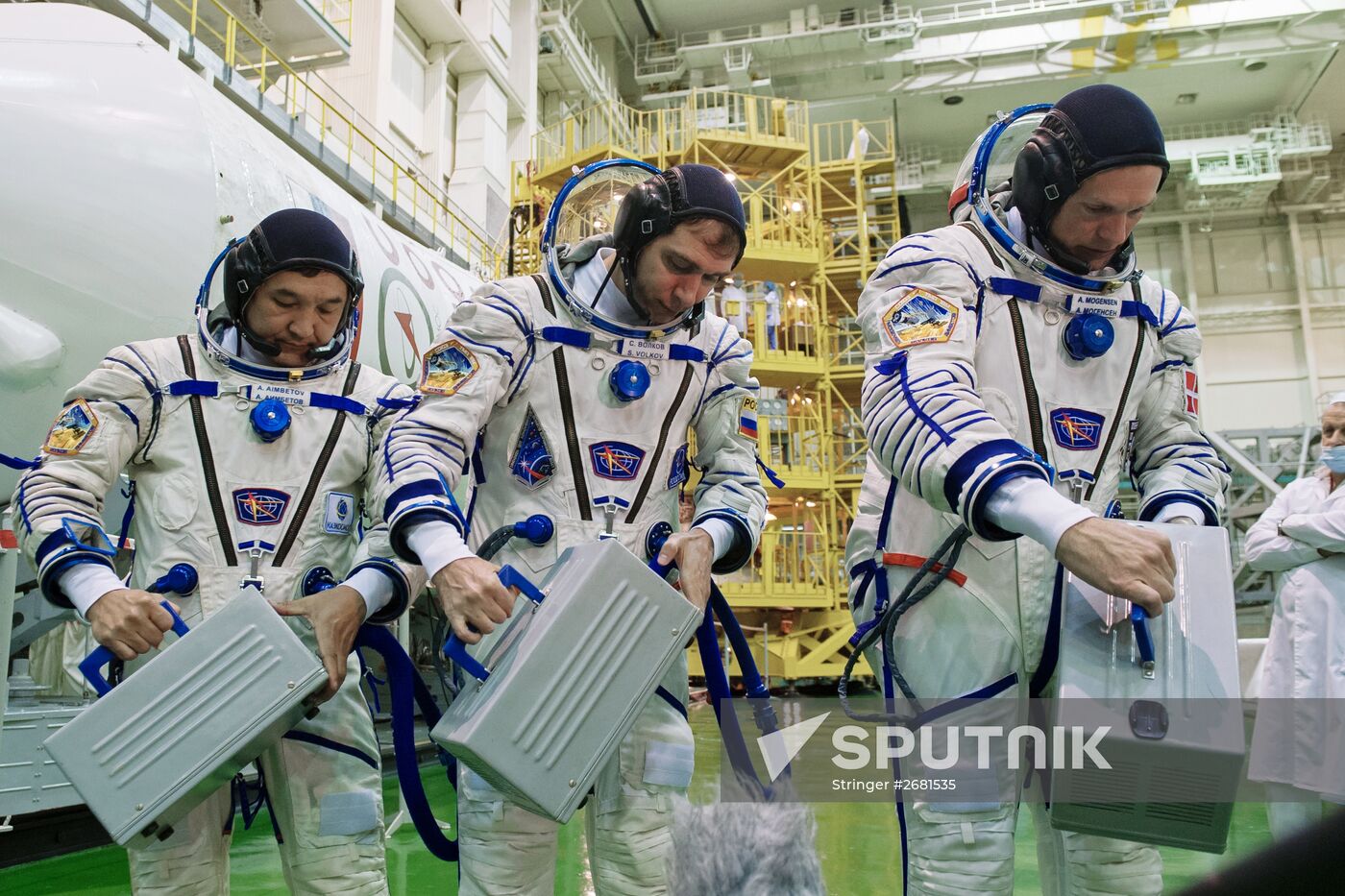 ISS-45/46 and Visiting Expedition 18 primary crew try on space suits and inspect space ship