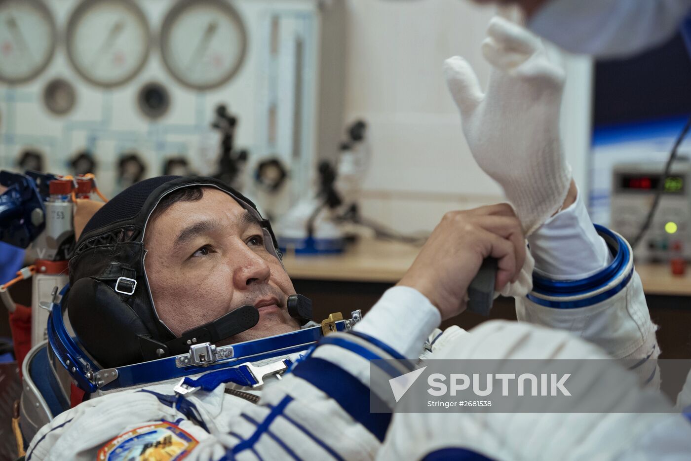 ISS-45/46 and Visiting Expedition 18 primary crew try on space suits and inspect space ship