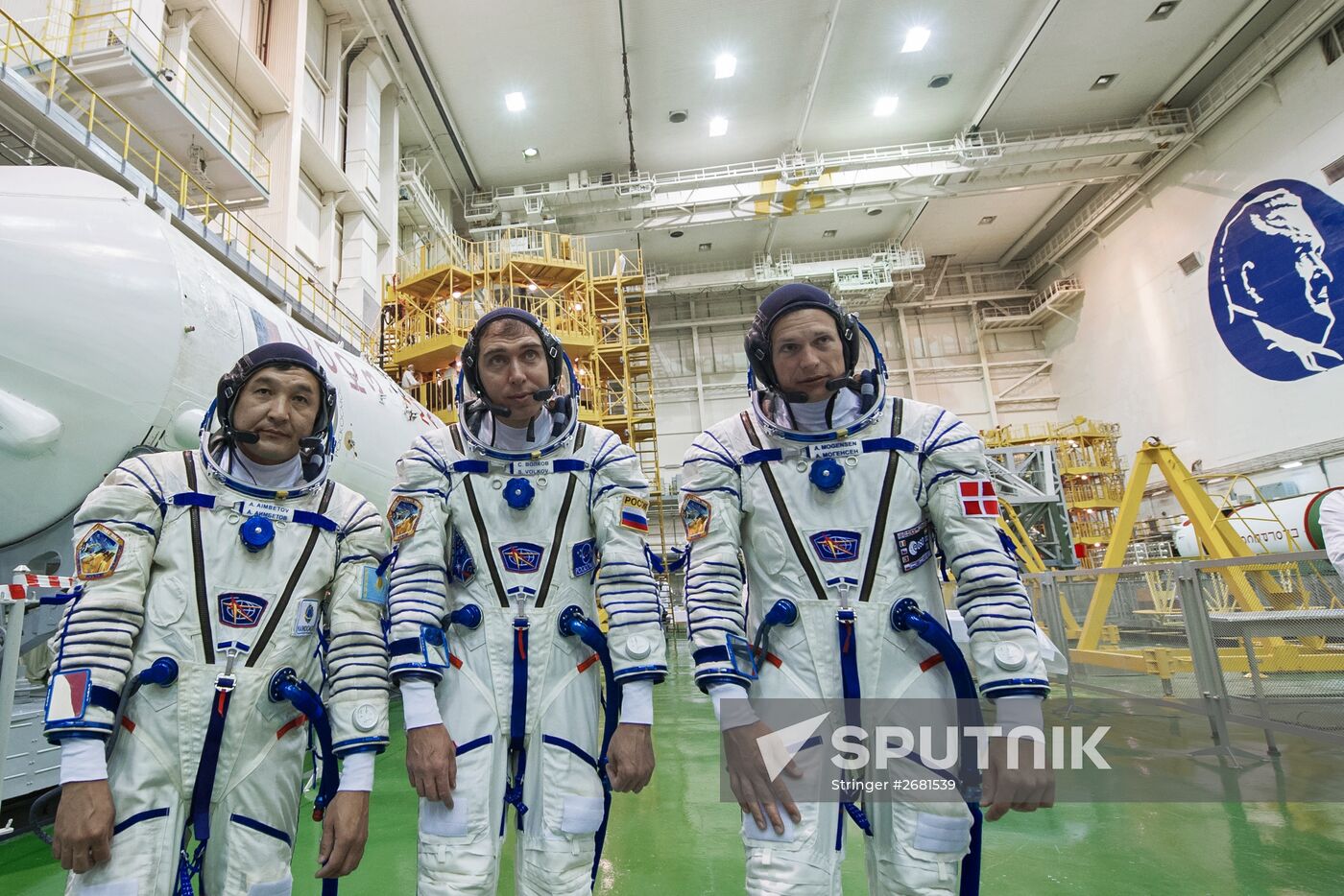 ISS-45/46 and Visiting Expedition 18 primary crew try on space suits and inspect space ship