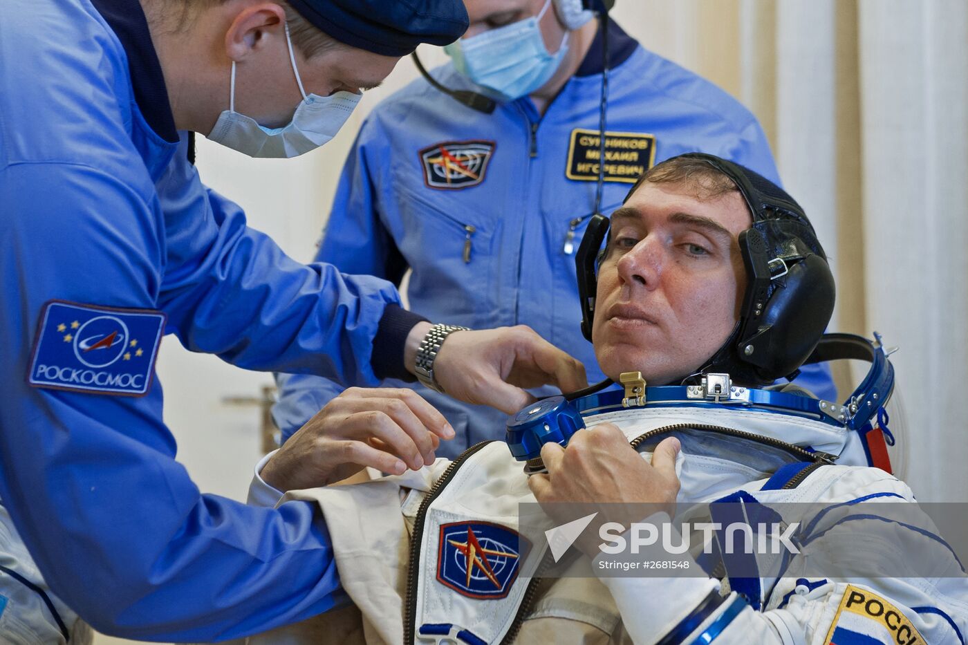 ISS-45/46 and Visiting Expedition 18 primary crew try on space suits and inspect space ship