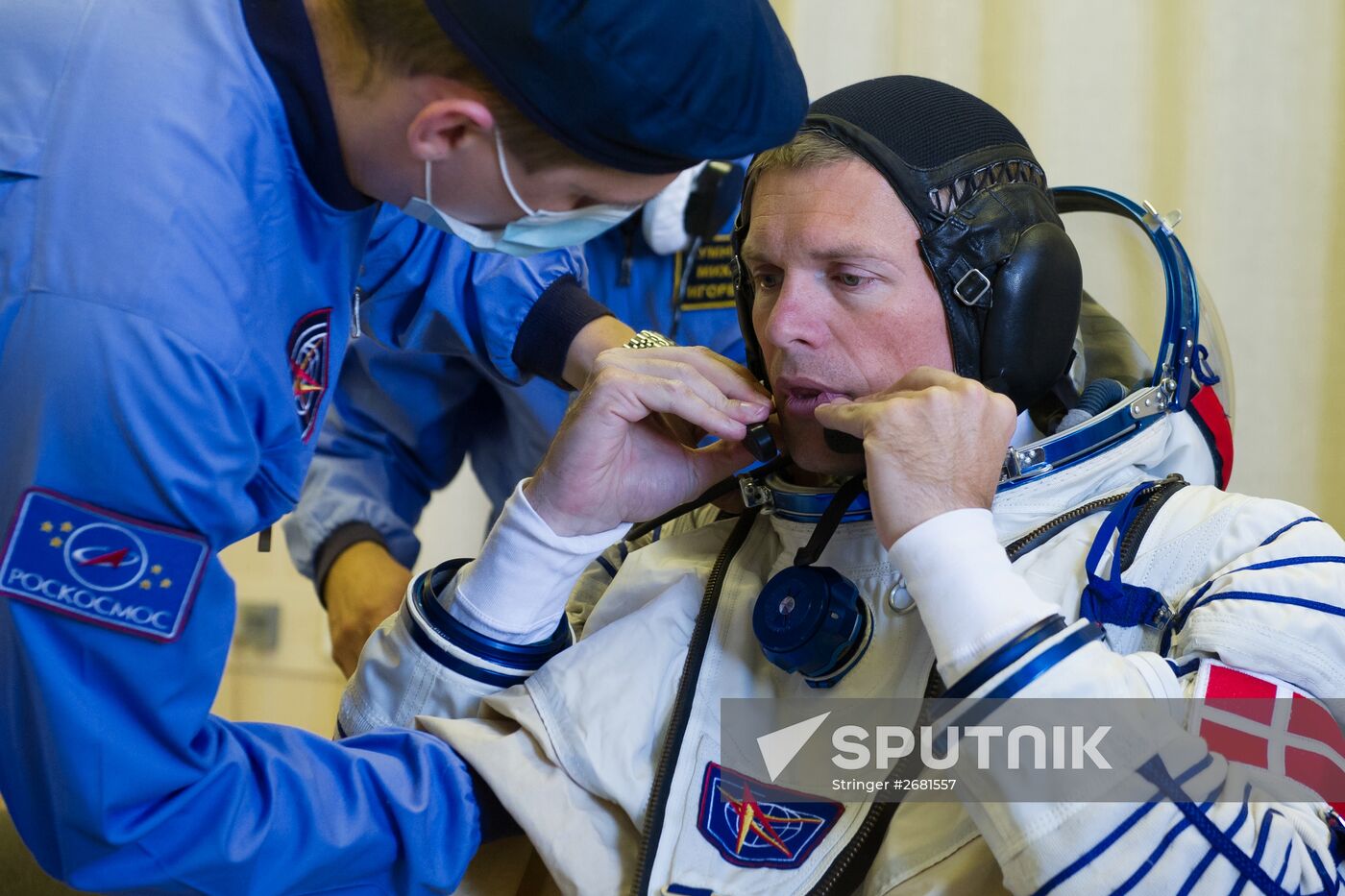 ISS-45/46 and Visiting Expedition 18 primary crew try on space suits and inspect space ship