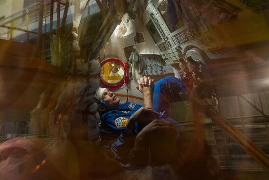 ISS-45/46 and Visiting Expedition 18 primary crew try on space suits and inspect space ship