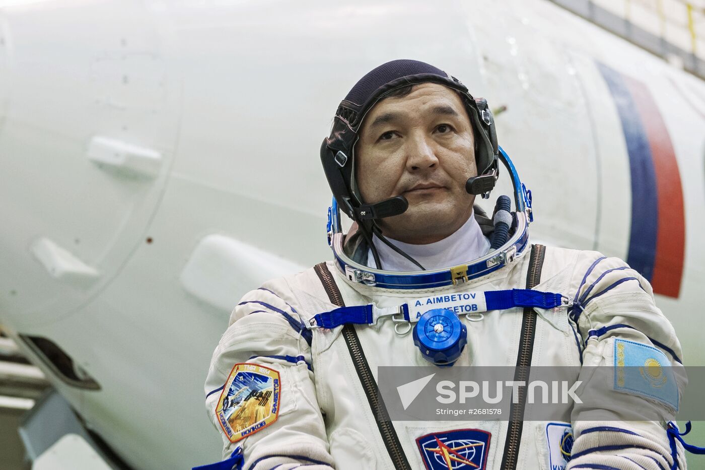 ISS-45/46 and Visiting Expedition 18 primary crew try on space suits and inspect space ship