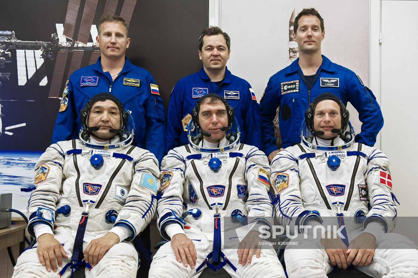 ISS-45/46 and visiting expedition 18 primary crew try on space suits and inspect space ship