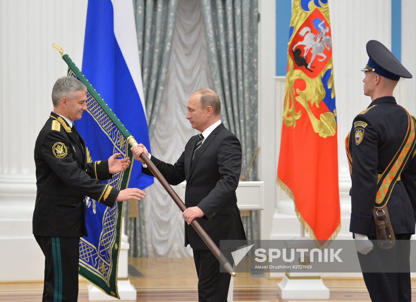 Russian President Vladimir Putin presents banner of Federal Bailiff Service