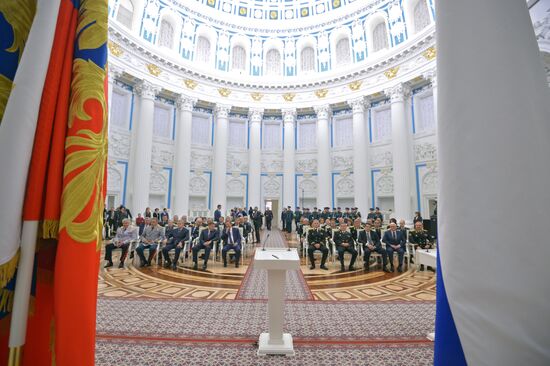 Russian President Vladimir Putin presents banner of Federal Bailiff Service