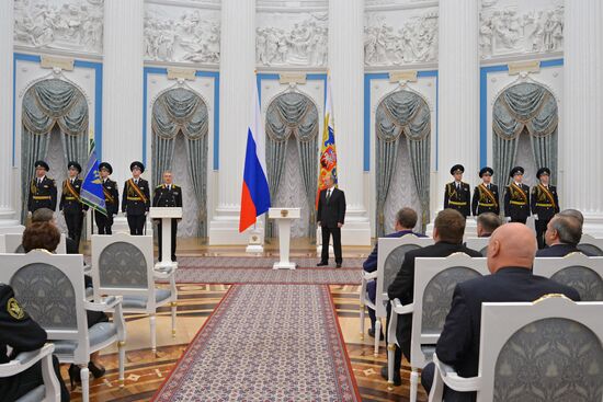 Russian President Vladimir Putin presents banner of Federal Bailiff Service