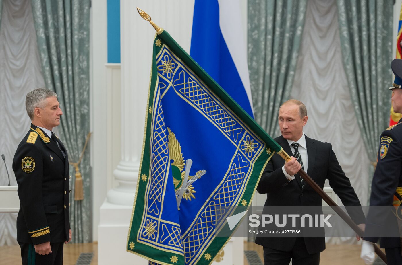 Russian President Vladimir Putin presents banner of Federal Bailiff Service