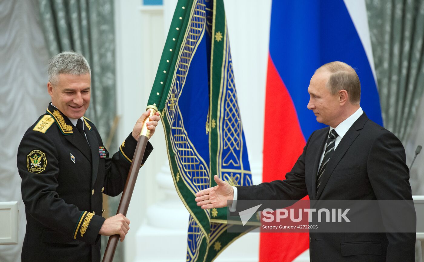 Russian President Vladimir Putin presents banner of Federal Bailiff Service