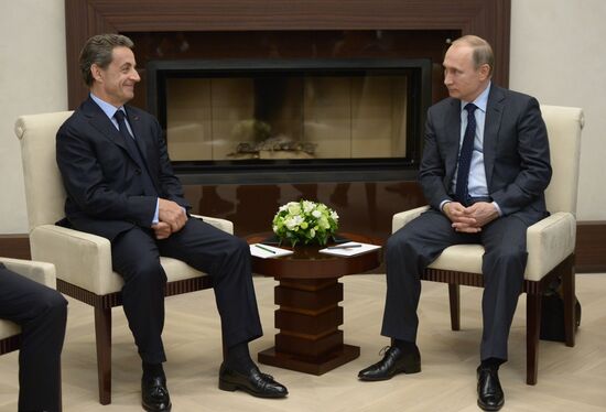 Russian President Vladimir Putin meets with France's former President Nicolas Sarkozy